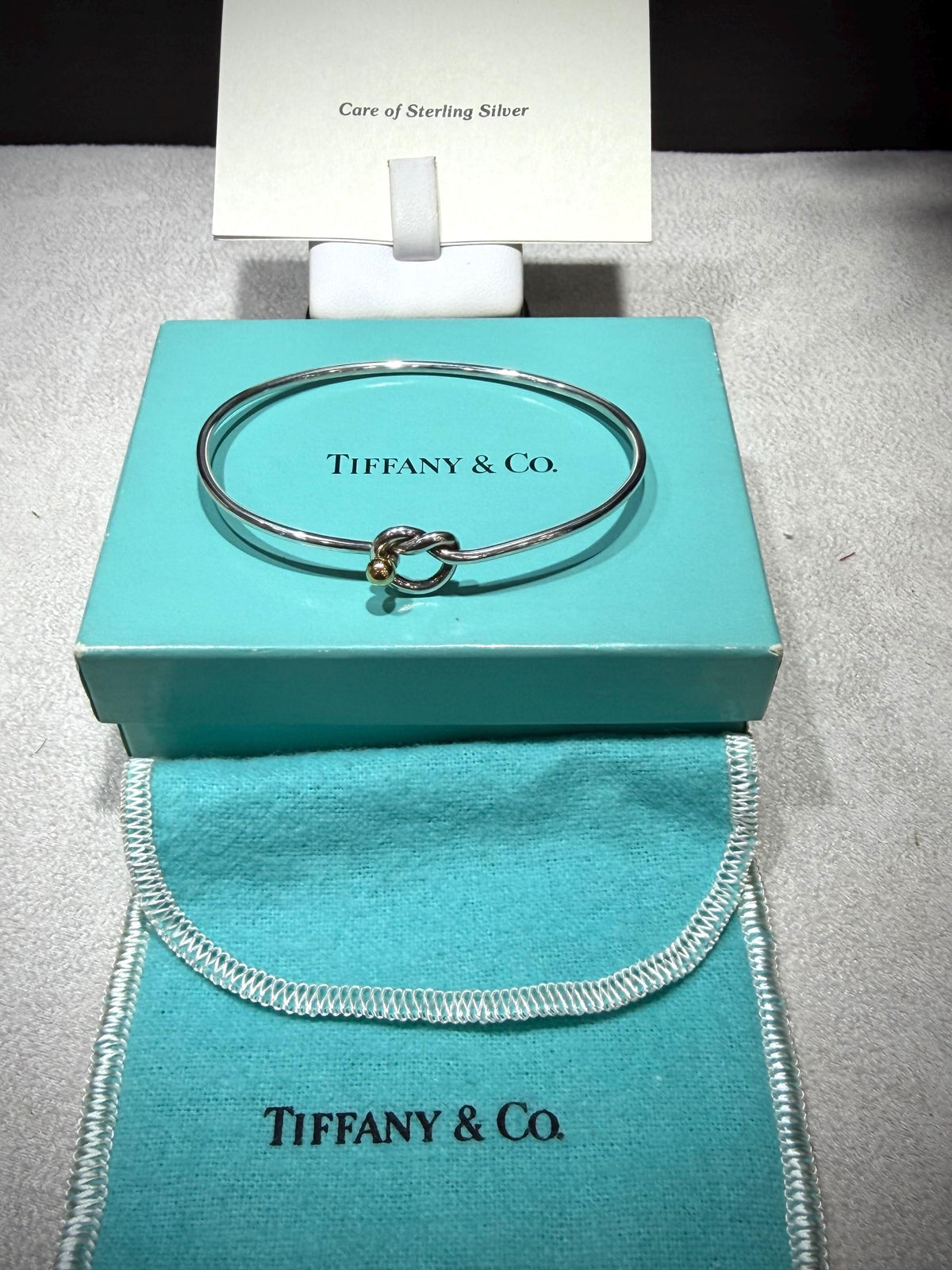 Tiffany & Co. 18K Gold Heart Love Knot Twist Sterling Silver Bangle Bracelet 925 750 with Box, Pouch, and Care Card.