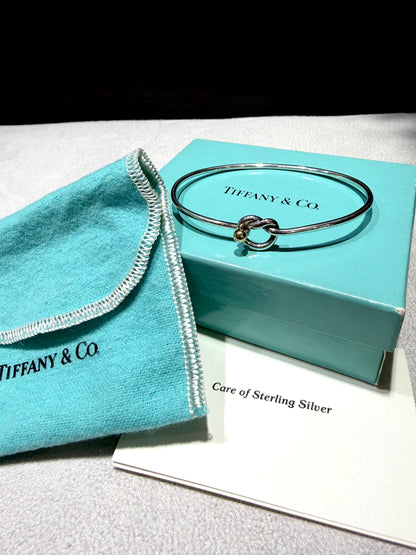 Tiffany & Co. 18K Gold Heart Love Knot Twist Sterling Silver Bangle Bracelet 925 750 with Box, Pouch, and Care Card.