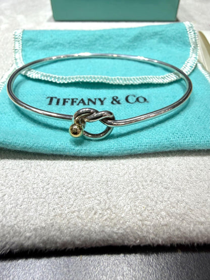 Tiffany & Co. 18K Gold Heart Love Knot Twist Sterling Silver Bangle Bracelet 925 750 with Box, Pouch, and Care Card.