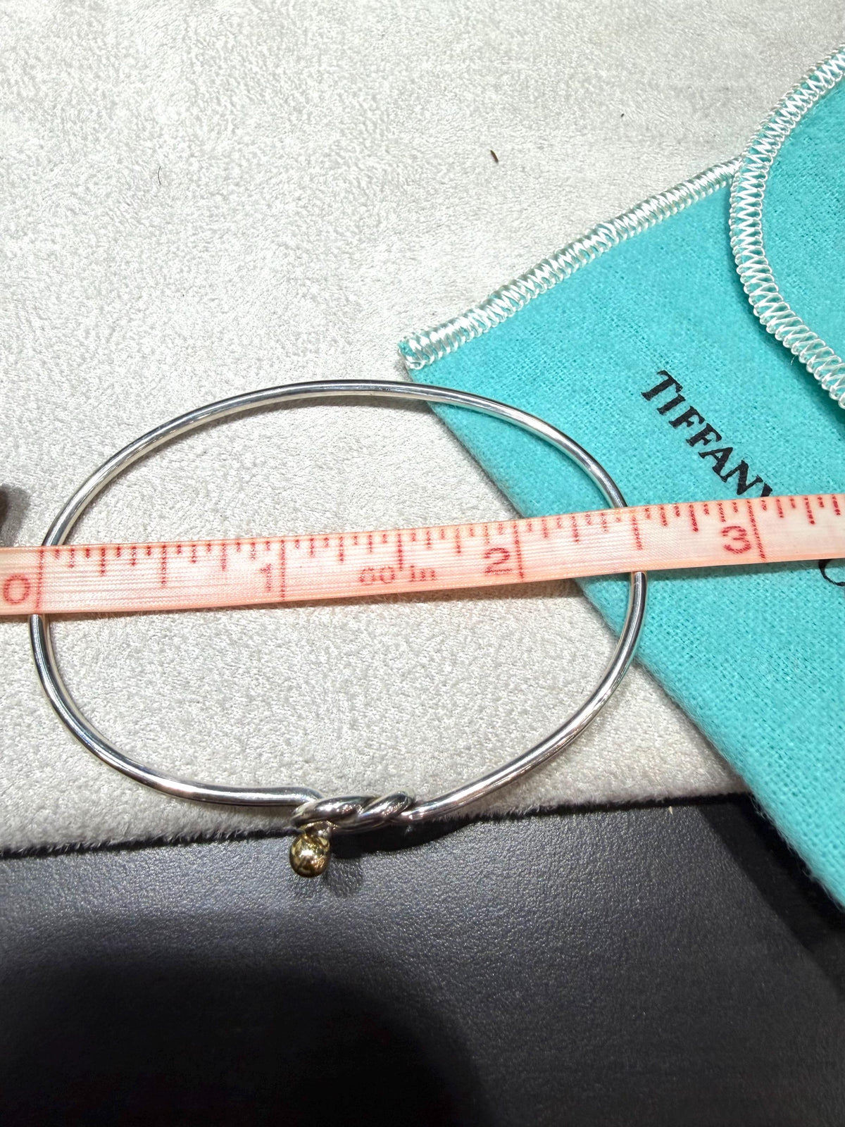 Tiffany & Co. 18K Gold Heart Love Knot Twist Sterling Silver Bangle Bracelet 925 750 with Box, Pouch, and Care Card.